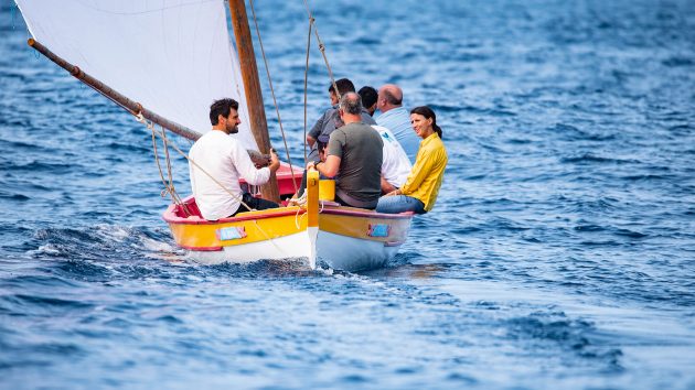 People on a small whaler during a race.