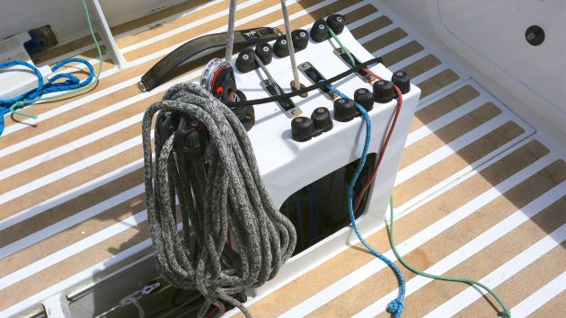 The central cockpit console on The Yachting World Diamond, surrounded by a sunny wooden deck.
