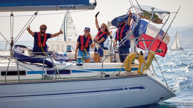 Four people looking happy on the yacht with the sun behind