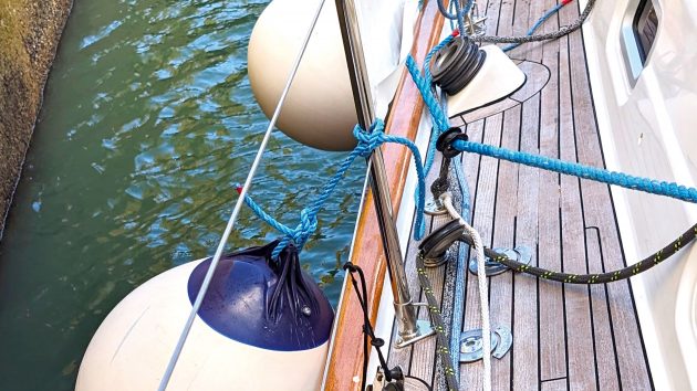Photo of the side of the deck with the buoys on the side and ropes.